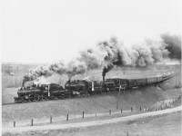 This photograph of the train running near Cheltenham shows the entire train of three locomotives and 14 cars! A quarter mile long and nearly 1000 tons.  The lightweight baggage car with electric generator for tape recorders and gated doorways typical for railfan excursions as well as food and drink supplies for the vendors who went though the cars.  Two lightweight air conditioned coaches with reclining seats are next. Two more were substituted for higher seating capacity heavyweight coaches more typical for a train of the steam era.  Even more seating would have been of benefit to the hundreds of people turned away. It would however have spoiled the appearance of the train so I stopped there.  Two ancient wooden coaches (1595 and 1596) brought up the tailend to represent earlier years.  These cars were brought to Toronto from The Glen Yard in Montreal along with a spare protect coach 1583.  A dining car was placed in the train to provide full meal service complete with a special souvenir menu.  The CPR wanted to add a second dining car to handle the anticipated demand however; they wanted to reduce a coach stating they didn’t feel the engines could not handle 15 cars. I refused because the loss of about 80 tickets would have meant the loss of any profit.  This was a very expensive event.   Had a third D10 (1087) been used the second diner and perhaps another coach could have been handled however the 136 was already committed to.  Besides, it would not have been the big drawing card without the little 4-4-0. <br><br>Note the new white classification flags and white canvas curtains applied to the engines as the CPR went all out dressing up the engines in passenger special trim including white tyres, silver armoured cable to head and class lights as well as builders plates. Red paint inside the bells!  Even new bell ropes.  Engines and tenders were cleaned and painted, cab interiors painted CPR standard green with red trim. Too much paint in fact.  All the valves etc. were freshly repainted black BUT the CPR wanted Passenger Special trim which meant polished brass everywhere! I recall checking on the engines a day or two in advance at Lambton roundhouse where I worked and found a labourer with a big file hand filing the fresh paint off the brass valve nuts! What a job!  I quickly left the cab without saying anything before he blamed me!<br><br> Raymond L. Kennedy CPR Retired  