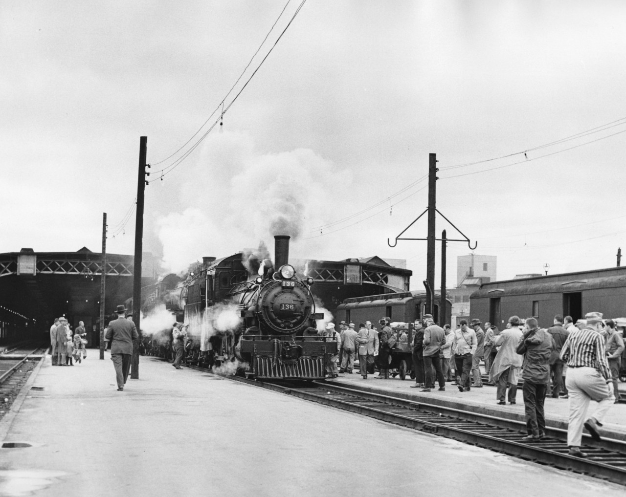 It is shortly before 10:45 A.M. on a cool, grey day Sunday May 1st.1960. A day that would go down in history. Billed as "An Old Fashioned Springtime Excursion" it would later become known far and wide as the"Tripleheader".  The steam era was drawing to a close and railfan clubs were operating excursions, usually with one locomotive and sometimes with two, but never before were three locomotives used! They were required to haul the heavy train up the steep grade between Forks of Credit and Cataract on the way to Orangeville. A record 14 cars and a record passenger count of 1,057 paying passengers. This matched the engine number 1057! Pass holders and small children along with railway personnel brought the total to over 1100. Hundred more were turned away! The engines could haul no more cars so the ticket sales were cut off two weeks in advance also something unheard of. 

Today I am celebrating my birthday by making my first contribution to this excellent website. Raymond L. Kennedy