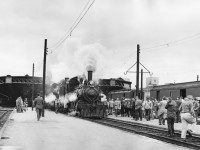 It is shortly before 10:45 A.M. on a cool, grey day Sunday May 1st.1960. A day that would go down in history. Billed as "An Old Fashioned Springtime Excursion" it would later become known far and wide as the"Tripleheader".  The steam era was drawing to a close and railfan clubs were operating excursions, usually with one locomotive and sometimes with two, but never before were three locomotives used! They were required to haul the heavy train up the steep grade between Forks of Credit and Cataract on the way to Orangeville. A record 14 cars and a record passenger count of 1,057 paying passengers. This matched the engine number 1057! Pass holders and small children along with railway personnel brought the total to over 1100. Hundred more were turned away! The engines could haul no more cars so the ticket sales were cut off two weeks in advance also something unheard of. 

Today I am celebrating my birthday by making my first contribution to this excellent website. Raymond L. Kennedy
