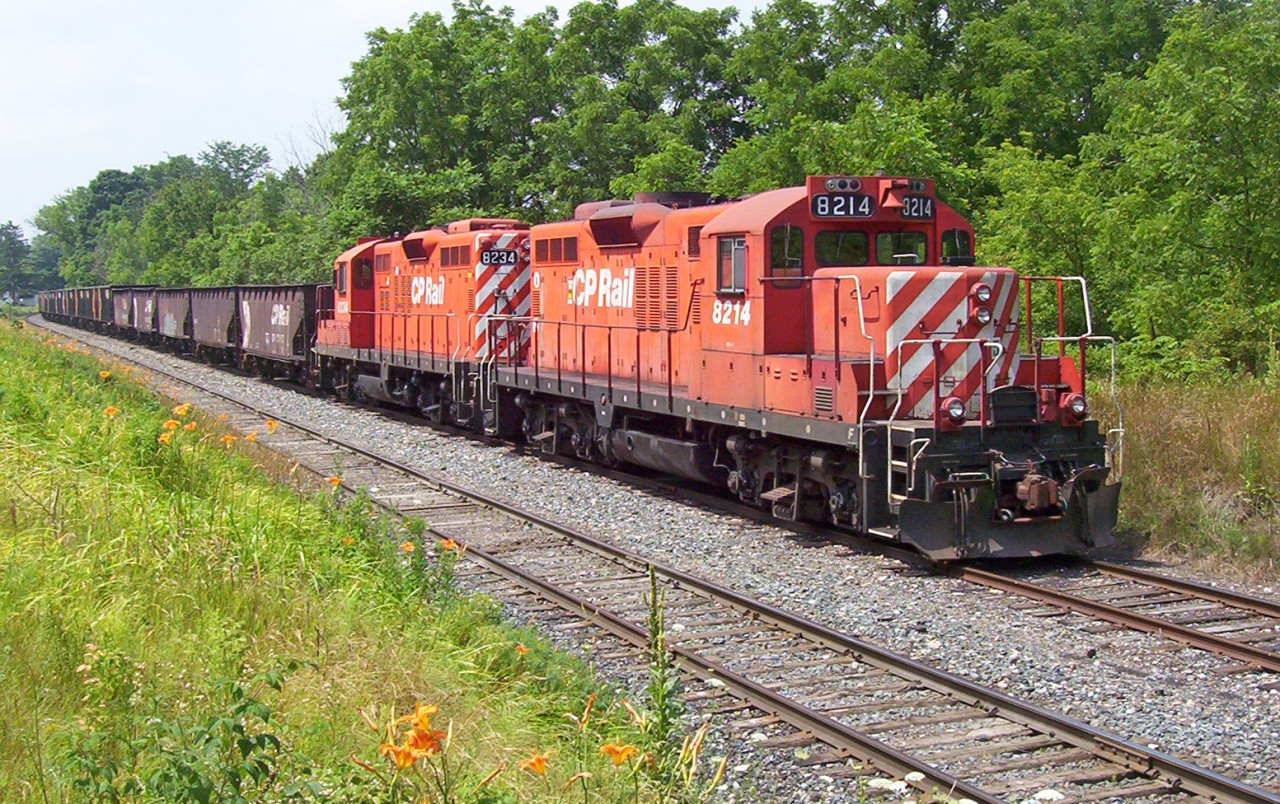 It does not feel like it, but it has been just over ten years since I took this shot. OSR operates this line now, the CP GP9u's are almost history. Here we have a ballast train parked on the Beachville siding along the St.Thomas Subdivision on a very nice summer day. The train would later be picked up by the Putnam switcher returning to Woodstock becoming an awesome lash up of 3 GP9u's and one GP7u.