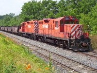 It does not feel like it, but it has been just over ten years since I took this shot. OSR operates this line now, the CP GP9u's are almost history. Here we have a ballast train parked on the Beachville siding along the St.Thomas Subdivision on a very nice summer day. The train would later be picked up by the Putnam switcher returning to Woodstock becoming an awesome lash up of 3 GP9u's and one GP7u. 