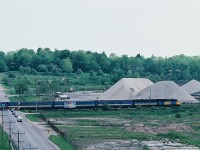 A pair of  MLW 's,  FPA-4 and FPB-4,  have the Montreal morning departure Lakeshore at speed through the McCowan Road crossing on the approach to CN Scarboro Junction. At this date train #53  offered Via 1 and checked baggage services.
<br>
<br>
For those who maybe familiar with the westend of the Kingston Subdivision – near the Eglinton Go station – this area is almost unrecognizable today, changes include
<br>
<br>
- the aggregate business and associated rail access / sidings long gone
<br>
<br>
- grade separation – McCowan now passes under the Kingston Subdivision
<br>
<br>
- a big box hardware retailer now occupies the south east (left) corner Eglinton – McCowan
<br>
<br>
- housing development on the south side of the Kingston Subdivision – east (left)  side of McCowan
<br>
<br>
- several apartment buildings at the south west (right) corner Eglinton – McCowan:  nursing home / seniors residence  and two separate condominium towers
<br>
<br>
The view from my condo, spring 1984 Kodachrome by S. Danko
<br>
<br>
sdfourty.