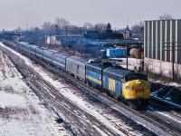You are seeing triple
<br>
<br>
A Kodachrome with three trains
<br>
<br>
 ( at one time Via was quite creative ! )
<br>
<br>
Via #44
<br>
<br>
Via #54
<br>
<br>
Via #2
<br>
<br>
Approach CN Scarboro Junction – also now known as GO Scarborough –  long before a  Metrolinx
<br>
<br>
What's interesting:
<br>
<br>
The equipment pictured in this Kodachrome – at the time this positive was exposed ( 1983 ) – was  28 to 29 years old, mostly  built by GMD / Budd / CCF (Canadian Car & Foundry - Montreal)  circa 1954 – 1955. Do consider, when you view this, the LRC equipment  built by Bombardier circa 1981 – 1984 ( Via 3300 and 3400 series coaches, many since re-furbished ) that comprise the bulk of the Via  inter-city equipment  right now and for the foreseeable future are today OLDER than ALL the equipment pictured here !
<br>
<br>
From the Kennedy Ave overpass, a February 13, 1983 Kodachrome by S.Danko.
<br>
<br>
More Kingston Subdivision
<br>
<br>
<a href="http://www.railpictures.ca/?attachment_id=8807">  FPA's !  </a> 
<br>
<br>
<a href="http://www.railpictures.ca/?attachment_id=16769">  more FPA's !  </a> 
<br>
<br>
sdfourty.

