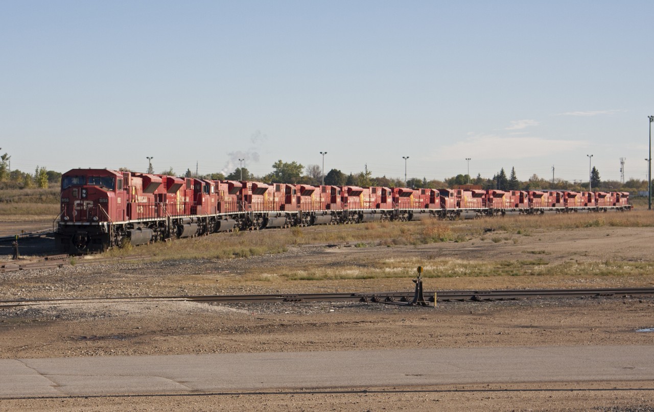 It's a 90's kinda day. These GMDD London build SD90's sit on the storage track at CP's Winnipeg Yard, with this being the era of "EHH" they could most likely be sold of or await it's fait to the torch none the less they sit basking in the sun on a warm October morning. 
If I recall 4 are back in revenue service.