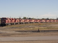 It's a 90's kinda day. These GMDD London build SD90's sit on the storage track at CP's Winnipeg Yard, with this being the era of "EHH" they could most likely be sold of or await it's fait to the torch none the less they sit basking in the sun on a warm October morning. 
If I recall 4 are back in revenue service.