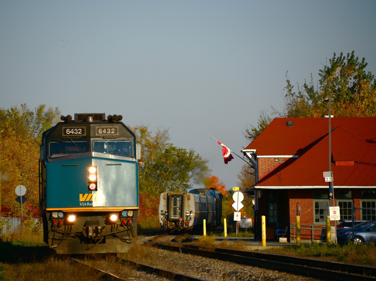 A warm autumn afternoon finds VIA Rail train 59, bound for Ottawa and Toronto, in a running meet with train 28 heading for Montreal and Quebec City at Alexandria ON in bright fall colours. Train 59 is being pulled by F40PH 6432 and 28 is in the charge of a P42.
