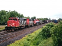 Heading to the USA and Conrail's Frontier Yard in Buffalo, CN 5362 and 5363 have in tow two newly retired M630(W) locos late of BC Rail; 730 and 701, sold to General Electric. In this time frame quite a number of these '630' locomotives went to GE, and they gathered en-mass at Frontier. Of the CN SD40-2(W, numerically the last two of a large block on the roster (5241-5363) the 5362 was still active as of early 2014 whilst the other was retired in 2010. In the background on the right one can see the old Merritton city yard, as well as the station, which burned down a few years later.