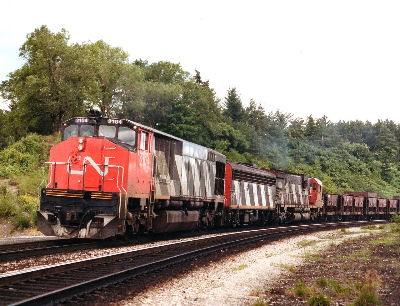 A rather noteworthy lashup on an eastbound Slag Extra which is about to enter the Oakville Sub off the Dundas at Bayview Junction, Hamilton. Rare combination, even for back in the '80s.  CN 2104, 9195 and 2008; Leader BBD HR616 retired by 1998, trailing unit gone by 1996 and the GMD F7Bu was history by 1989. I had seen slag trains off and on but never did find out where they came from or where they were headed.  Anyone??