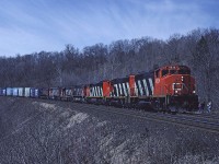 CN GP40-2W 9526 leads a mixed bag of MLW and GMD downgrade past the site of Dundas station with train #410 with a number of auto parts cars on the head end. 