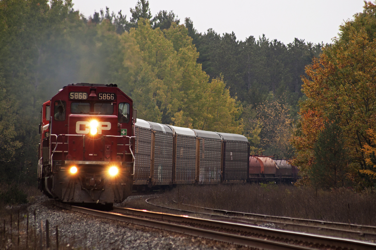 After meeting the 8891 S at Baxter, the 5866 N throttles up the grade at Midhurst with clearance to Mactier.