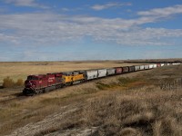 Westbound grain train fights up the grade east of Chokio Alberta