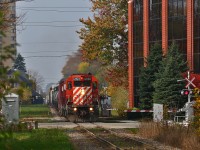 CP 242 climbs up from the bridge over the Thames river and Oxford street, at the base of the hill down from Lobo, with an impressive consist of CP 6050-5966-HLCX 6337. A small break in the clouds shows on an otherwise cludy morning shows off what remains of this year's fall colours. The train would tie down in Quebec street yard, with the power continuing east on 244 later in the evening. The entire train was dropped at London to be switched out by the yard crew... tomorrow. With SD40-2's leading and a leased unit in the consist, this train seems like a flashback to the pre-EHH era on CP! 