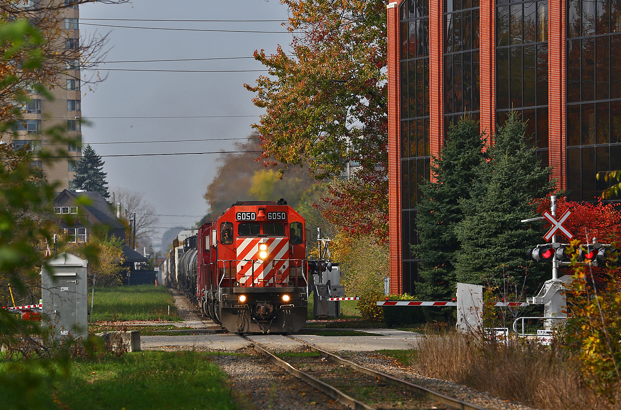 CP 242 climbs up from the bridge over the Thames river and Oxford street, at the base of the hill down from Lobo, with an impressive consist of CP 6050-5966-HLCX 6337. A small break in the clouds shows on an otherwise cludy morning shows off what remains of this year's fall colours. The train would tie down in Quebec street yard, with the power continuing east on 244 later in the evening. The entire train was dropped at London to be switched out by the yard crew... tomorrow. With SD40-2's leading and a leased unit in the consist, this train seems like a flashback to the pre-EHH era on CP!