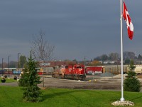 Having left their train tied down in the siding at Lobo, CP 244's power idles on what has to be the nicest shop track anywhere on the system (where else can you find a shop area fitted with giant flowerpots?!). A small hole in some fast-moving clouds allowed for a brief moment of storm lighting, which illuminated how ratty the paint was on the trailing unit (BNSF 899). The engines would spend almost the entire day parked on the shop track waiting for a new crew, who then took the power to Lobo to retrieve their train. Once back in London, the crew would do some more work (lifting 242's power, CP 6050-5966-HLCX 6337) before finally continuing east well after dark. 