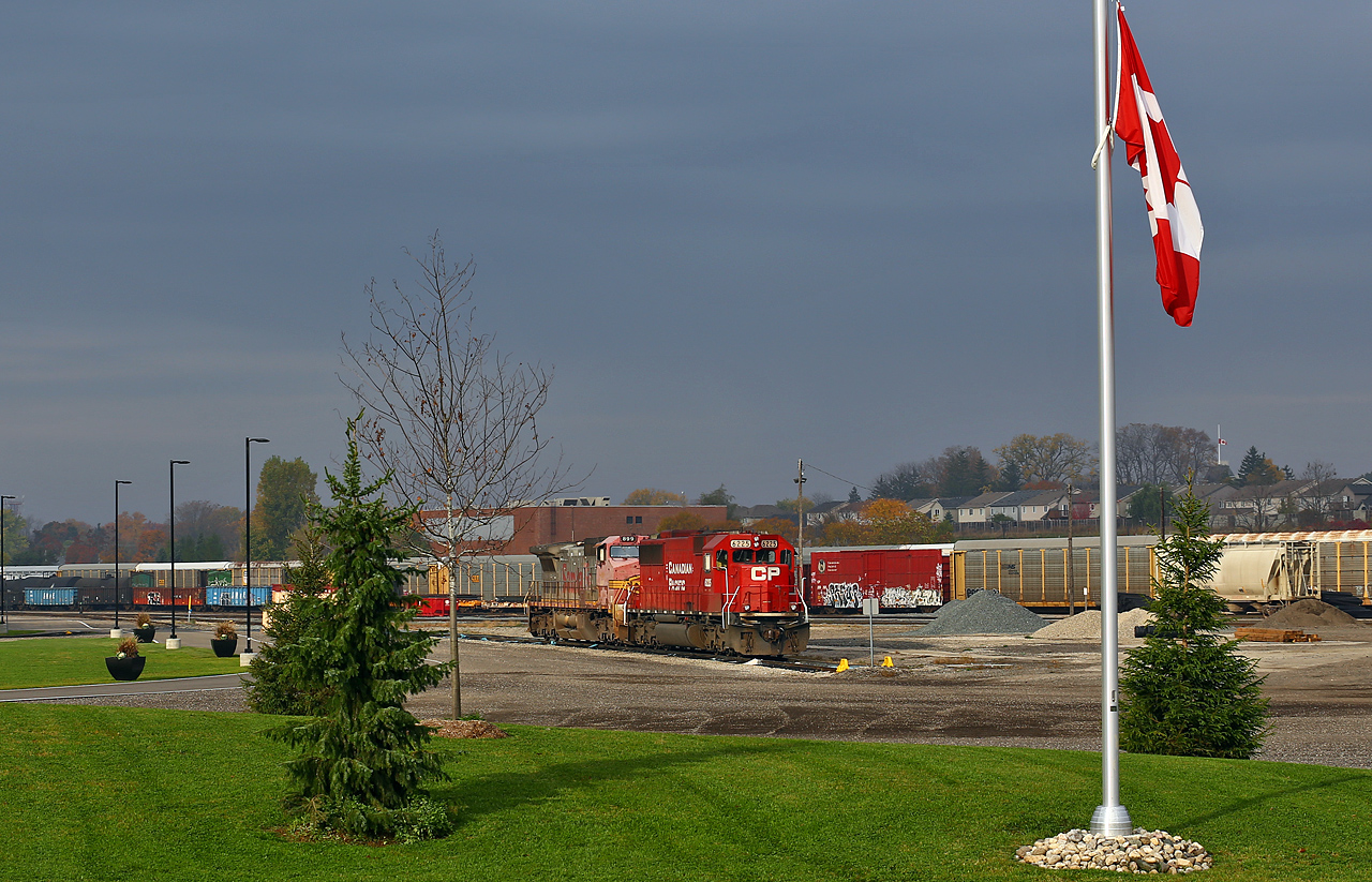Having left their train tied down in the siding at Lobo, CP 244's power idles on what has to be the nicest shop track anywhere on the system (where else can you find a shop area fitted with giant flowerpots?!). A small hole in some fast-moving clouds allowed for a brief moment of storm lighting, which illuminated how ratty the paint was on the trailing unit (BNSF 899). The engines would spend almost the entire day parked on the shop track waiting for a new crew, who then took the power to Lobo to retrieve their train. Once back in London, the crew would do some more work (lifting 242's power, CP 6050-5966-HLCX 6337) before finally continuing east well after dark.