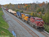 CP second 240 rolls alongside the newly extended east end of Spicer siding behind CP 8578, UP 8216, and CEFX 1007. The view here was vastly different a few short years ago, with the east end of Spicer being located back towards where the train disappears around the corner and CN was double tracked, as opposed to todays triple track. Had you visited last winter, you'd have found a temporary switch installed in the approximate location of the lead unit, however seeing as the new siding was not tied into anything at the west end, it was of no practical use. The chicane is also new, and likely in order to avoid a bridge pier. 1249hrs.