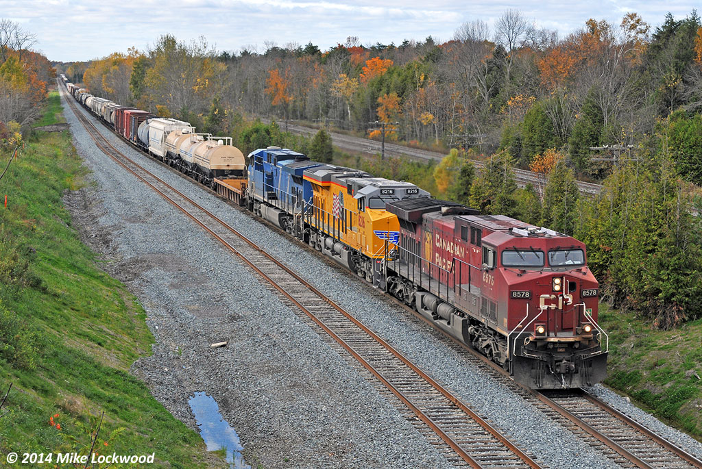 CP second 240 rolls alongside the newly extended east end of Spicer siding behind CP 8578, UP 8216, and CEFX 1007. The view here was vastly different a few short years ago, with the east end of Spicer being located back towards where the train disappears around the corner and CN was double tracked, as opposed to todays triple track. Had you visited last winter, you'd have found a temporary switch installed in the approximate location of the lead unit, however seeing as the new siding was not tied into anything at the west end, it was of no practical use. The chicane is also new, and likely in order to avoid a bridge pier. 1249hrs.