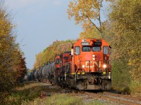 CN4725 with an industrial cut of tanker and hopper cars heads south out of Sarnia at LaSalle Road.