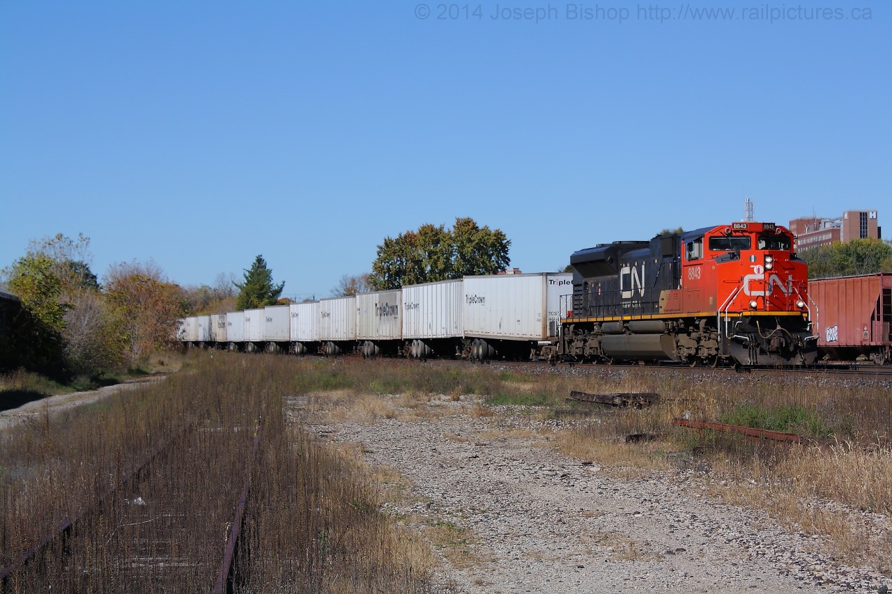 A late running CN 144 slowly limps through Brantford with CN 8843 on the point.  The crew was having quite the time with 8843, it would drop its load as soon as they got above notch 3 and they had to cut out a whole truck making them run on only 3 traction motors.