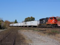 A late running CN 144 slowly limps through Brantford with CN 8843 on the point.  The crew was having quite the time with 8843, it would drop its load as soon as they got above notch 3 and they had to cut out a whole truck making them run on only 3 traction motors.  