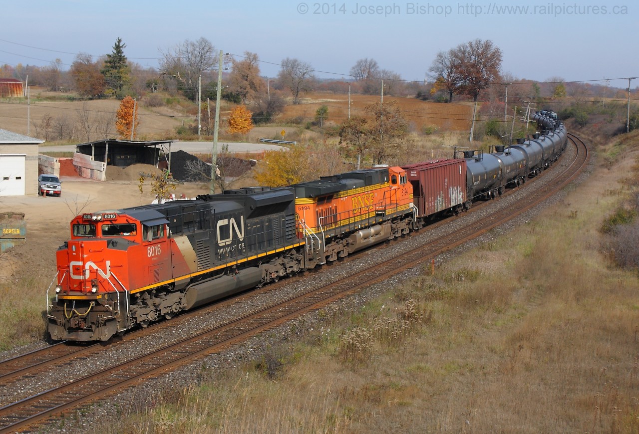A series of interesting events happened today on the Dundas Subdivision this afternoon.  CN 393 with CN 2648 and CN 9574 stalled around Mile 8 with CN U711 right behind them.  711 ended up coupling to 393's tail end and giving them a shove up the hill to Copetown West where they cut off and carried on their way.  Pictured we see U711 passing Garden Ave outside of Brantford with CN 8016 and BNSF 5194 shortly after 393 had passed on the South.