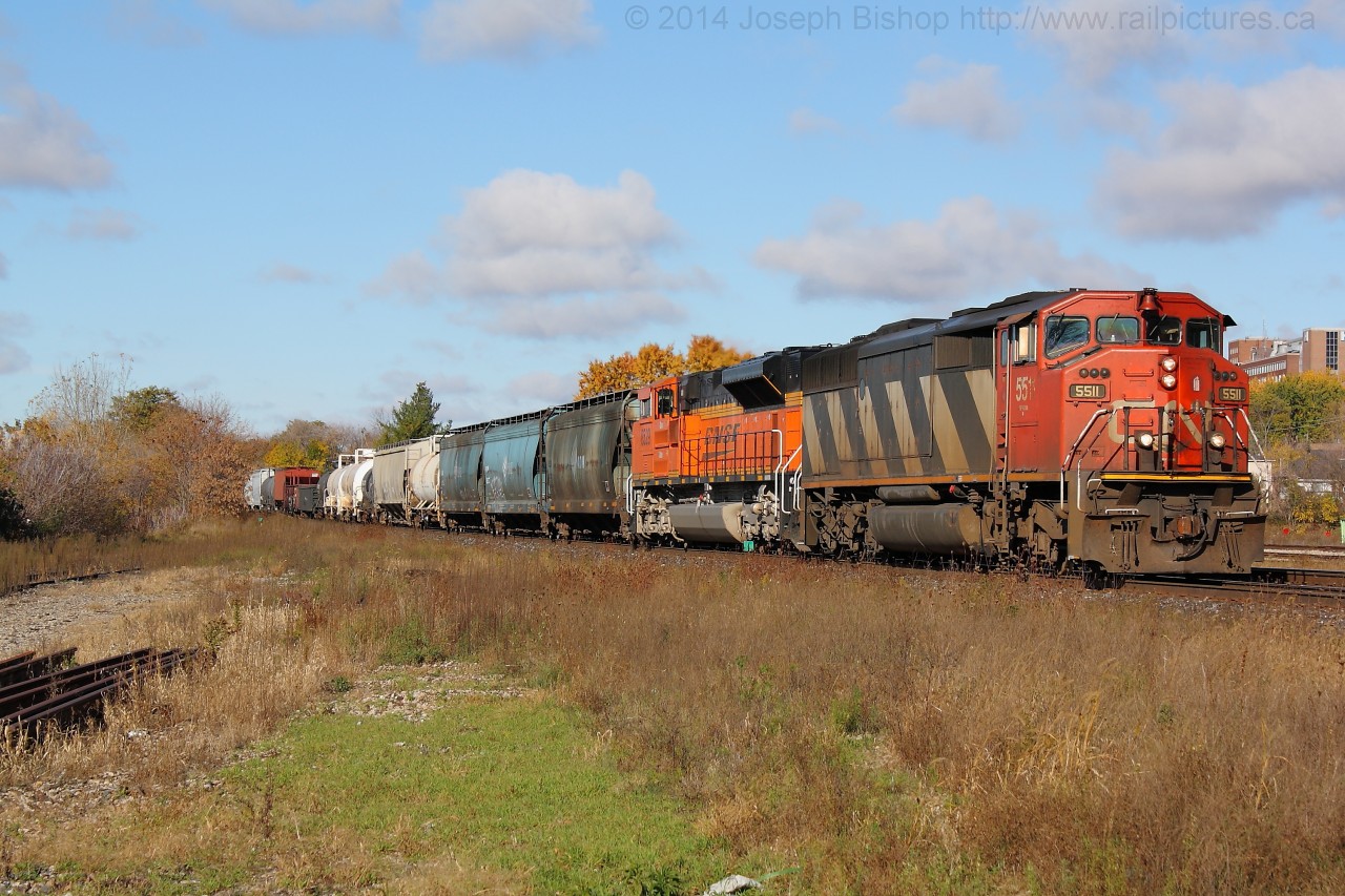 CN 5511 and BNSF 8529 power CN 396 by the West end of Brantford yard during a brief period of sun on a mostly cloudy day.