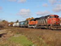 CN 5511 and BNSF 8529 power CN 396 by the West end of Brantford yard during a brief period of sun on a mostly cloudy day.
