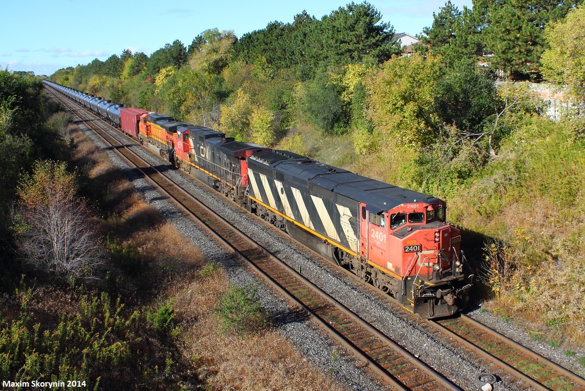After waking up and receiving a notification via Yahoo FPON that Canadian National train U71091 has passed Georgetown, ON with a Burlington Northern Santa Fe locomotive trailing. I decided to take the opportunity and get this train in perfect light, at my most visited location Hilda. Just seconds after setting up to my luck, I hear the growl of the engines and see it round the bend with the advertised power. I hope I'll try a different location next time.