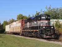 This day's BCRY train is passing through Barrie with one centre beam load of lumber for Tarpin Lumber and one hopper of sodium bentonite clay for TAG Environmental.