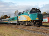 The eastbound lunchtime Via sets off from Woodstock on it's journey to Toronto. In the background the distinctive decorated boxcars.