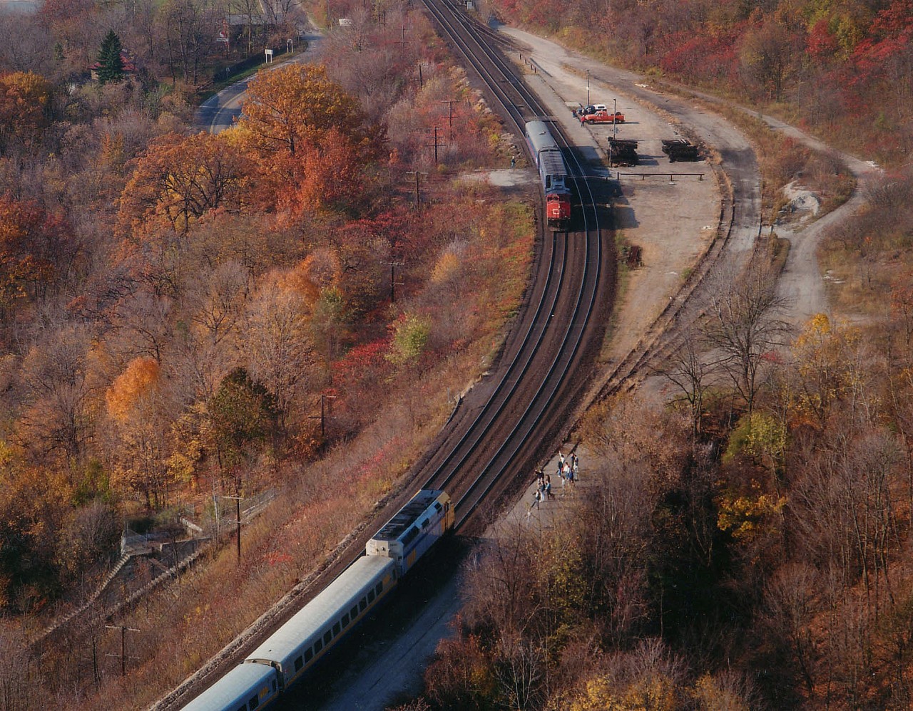 CN 9505 with a gang of Suits along for a tour of the line is passing the site of the old Dundas Station while westbound VIA #71, powered by 6435, commands the attention of Hamilton grade 11 high school class hikers that have just descended from the Peak Lookout where this photographer braved the cool winds of the day to capture some images before the fading fall colours are gone. Still a bit of colour for a November day.