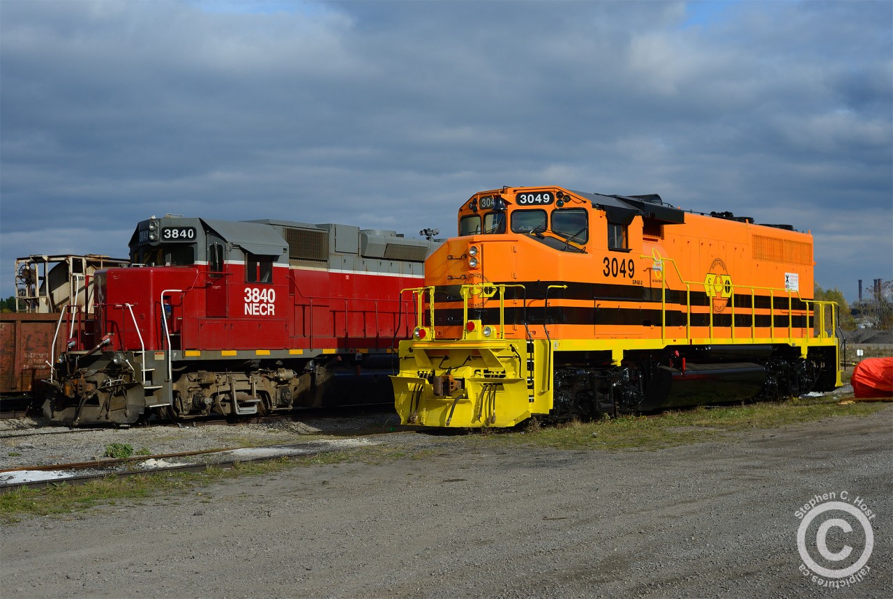 Railtex - meet Genesee & Wyoming. NECR 3840 sits at the Southern Ontario Railway's new Hamilton shop (by Railcare) while 3049 sits beside wearing the emperors new clothes in the form of G&W Orange. 3049, an obviously former CN engine was repainted at LDS in Sarnia from Gulf & Ohio painted, WGCR 9554 (exx YVRR exxx CN of the same number). Photo taken under supervision of, and with permission of the host railway.