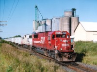 Not long before the demise of this service west of Toronto, we see CP's "Triple Crown" en route to Detroit with a pair of SOOs up front, 6054 and 6024. That is Niagara Milling in the background and the train is just rolling west over the Ayr Pit Spur switch.