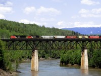 Prince Rupert bound grain loads train 835 crosses the Skeena River west of New Hazelton BC on the Smithers to Terrace Bulkley Subdivision