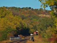 Train 246 heads south out of Hamilton as the trees on the Niagara Escarpment begin to change colour on a sunny October morning.
