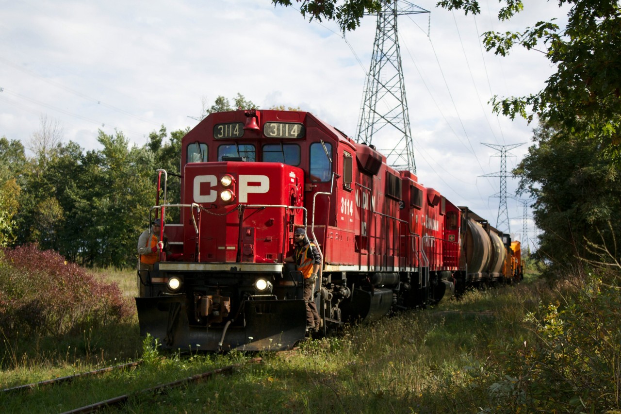The sound of a train horn from my home from where I have never heard a horn made me wonder if CP was lifting the Hydro One dimensional car and caboose from the spur leading to the Trafalgar facility spur. A line that has seen two transformer deliveries in the last three years. As luck would have it they were lifting the empty car, and are seen here crawling northbound at Britannia Road, running on a very weedy and rusty track.