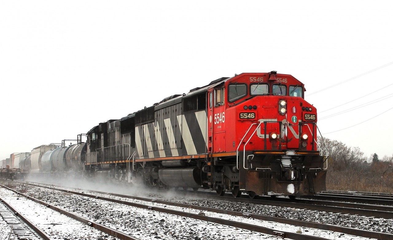 The snow had almost stopped when this eastbound arrived hauling a lot of tank cars. CN 5546 and IC 1009 were in charge of the train.