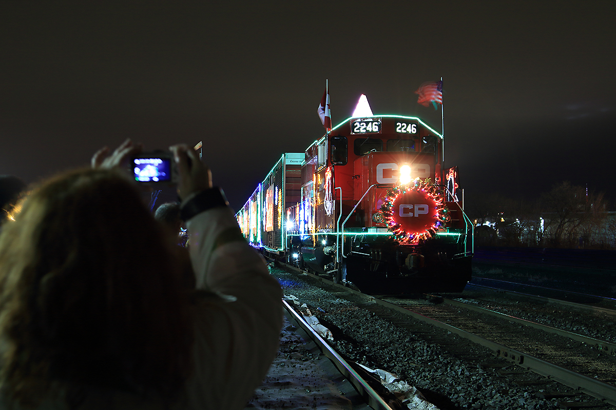 Right before she steps into frame she ask's me can I jump in to take a photo and I reply I don't mind at all. As she snaps a photo of the 2014 CP Holiday train with her iPhone and sure enough it works out perfectly a picture within a picture. Merry Christmas and Happy Holidays!!