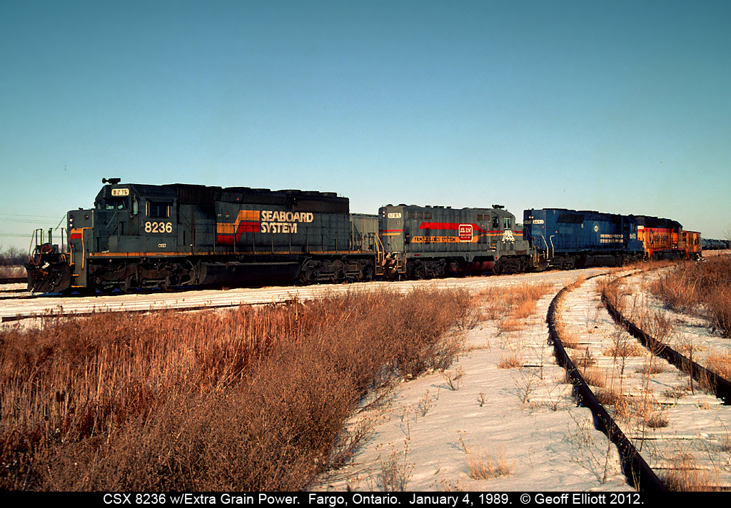 CSX in the late 80's was a "hodge-podge" of power.  Here we have a "Grain Extra" power set sitting in Fargo, Ontario after delivering an 80 car empty grain train to W.G. Thompson in Blenheim, Ontairo.  Power consist is a Seaboard System SD40-2, a Family Lines GP16, a VMV Leasing (ex-Conrail, exx-EL) SDP45, and a Chessie GP40-2 to round out the quartet.  This power was lifted by westbound R321 a little later which had a Chessie GP40-2 on the point, an Seaboard Coast Line (still in black) GP40, and a CSX SD40 for power when it arrived.  Wish it had still been light enough out to have shot that consist leaving that evening!!