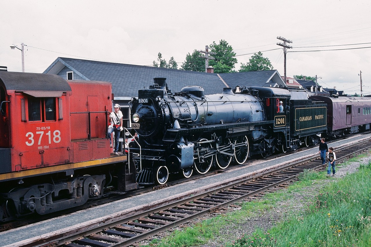Peter Newman's great shot ( & story ) of the 1201 /  FP7-A  lashup (  a candidate for a RP's “ Hall of Fame “ );


 see:     on the Belleville Subdivision   


( and is that Frank Bunker at 1201's throttle ? )



...reminded me of another 1201 doubleheader:  the G5a / RS-18  lashup at Charney P.Q.


 ( G5a #1201 a June 1944, CPR Angus Shops, Montreal build – CN #3718 a 1957, MLW RS-18, Montreal build )


Ex CPR 1201 – owned by the National Museum of Science & Technology ( and operated by ? )  -  was attending  the 450th anniversary celebration of the founding of Stadacona ( Quebec City ) by Jacques Cartier.


Uncertain what ailed the 1201 on this assignment – perhaps a viewer may be able to elaborate.


June 26, 1984 Kodachrome by S.Danko.


More CPR / exCPR  steam, including a double header:


   Wakefield  


    West Toronto  


   Leaside  



   Agincourt  


 Cherry Street  


sdfourty