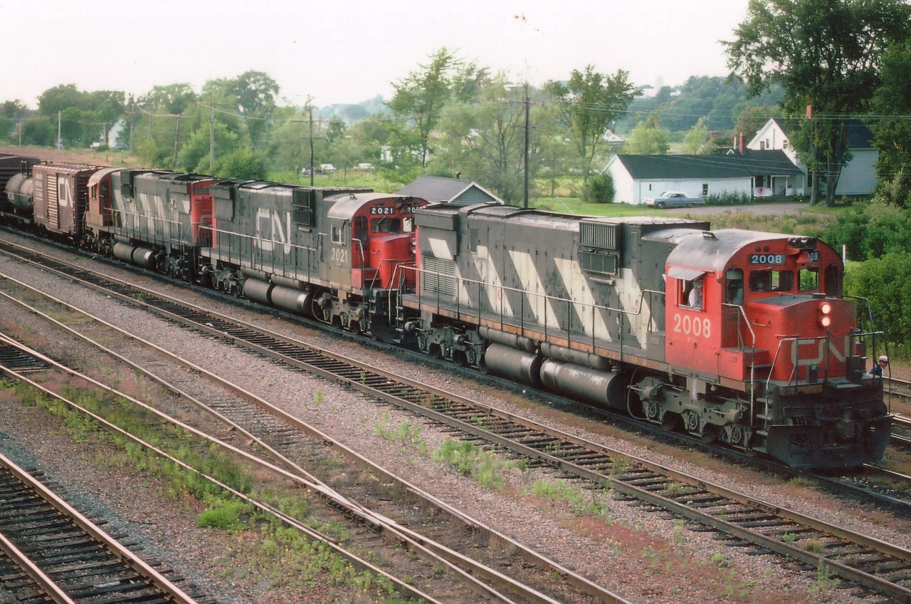 Admittedly these big grubby looking MLW products aren't the most photogenic locomotives of the past, but they sure were a memorial event when they rumbled by. For those who have heard their unique sound will never forget it. I sure miss them!! Bringing in a long train and then dropping it off at the yard just to the east of Truro are CN 2008, 2021 and 2023. All these M-420(W) behemoths on CN were retired or sold by 1996.