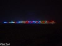 In the middle of the fields, and the night, the illuminated Canadian Pacific Holiday Train U.S. version is about to cross the border Canada/USA.