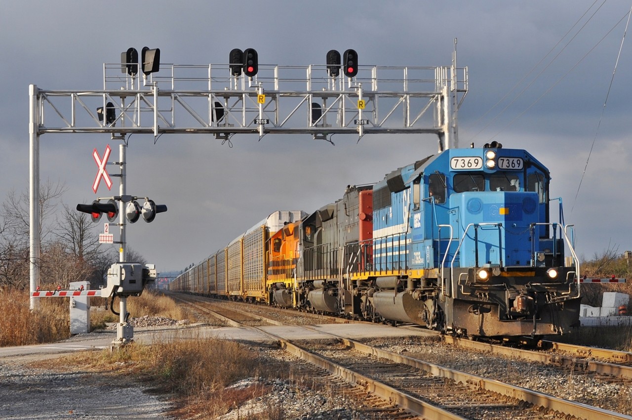 7369,3054, and 3393 are working hard to get their 108 auto racks, empty centre beams, and hoppers up the grade east of the Credit River.