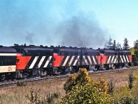 There is nothing like a five-pack of speeding, smoking, thundering, water-sloshing FPA-4s!  I think this image was snapped somewhere around Scarborough Golf Club Road, circa 1978.<br /><br />My research shows that the Montreal Locomotive Works built 34 of these units (numbered 6760 – 6793).  They were manufactured between 1958 and 1959, and were each rated at 1,800 HP.<br /><br />Want to see some additional water spillage?  Check out Mr. Danko’s  fantastic photograph at…<br /><br /><a href=http://www.railpictures.ca/?attachment_id=8807>http://www.railpictures.ca/?attachment_id=8807</a>