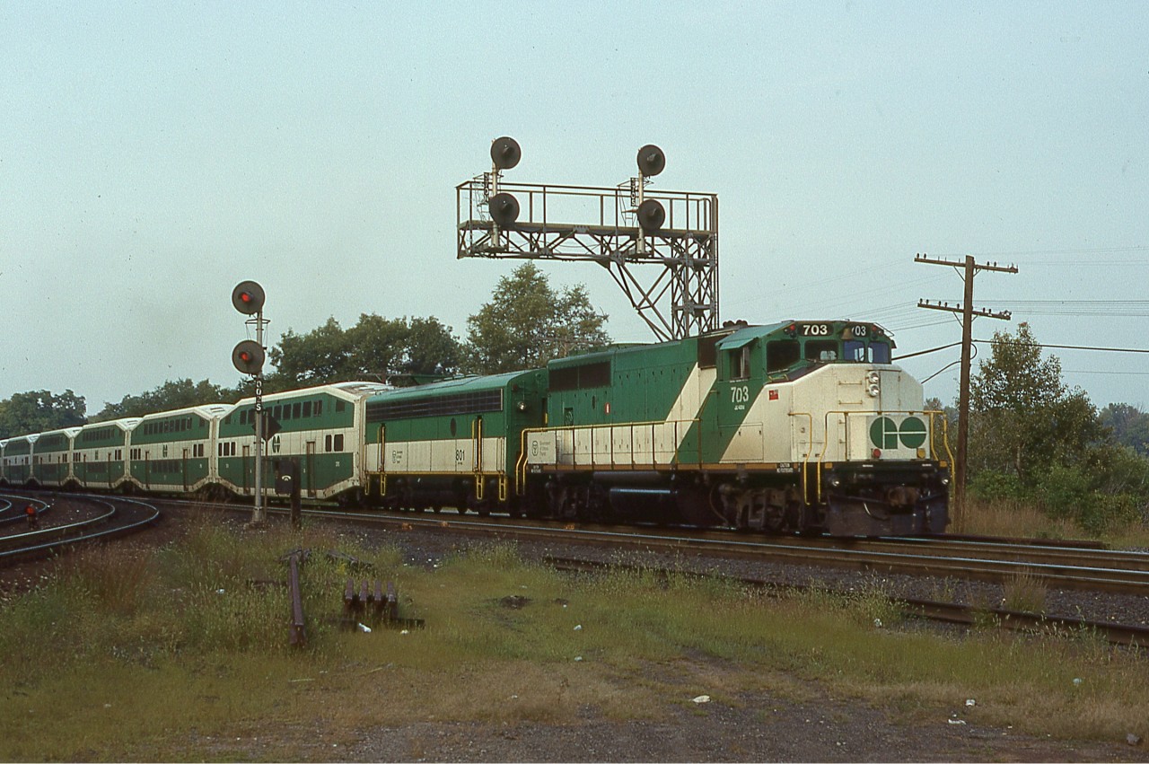 GO Transit GP40-2(W) No. 703 (built as No. 981 by GMD in December 1973) along with APU No. 801 (constructed as Northern Pacific F7B No. 6014B by EMD in 1951) deadhead eastward through Bayview Jct. with the usual compliment of bi-level coaches wrapping up the Friday evening commuter rush. Both units are still around; sold to Tri-Rail in Miami in 1991 No. 703 would eventually be acquired by Aberdeen, Carolina and Western while No. 801 would depart in 1994 to join her new owner as Ontario Northland No. 205.