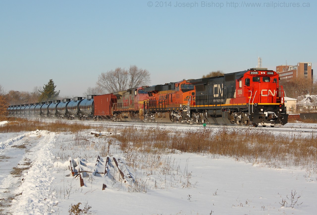 CN U710 cruises through Brantford on a brisk November morning with a stellar consist of CN 2006, BNSF 6825, BNSF 633.  The night before lake effect snow dropped several centimetres of snow across most of Southern Ontario making for a nice and wintery scene.