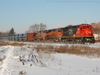 CN U710 cruises through Brantford on a brisk November morning with a stellar consist of CN 2006, BNSF 6825, BNSF 633.  The night before lake effect snow dropped several centimetres of snow across most of Southern Ontario making for a nice and wintery scene.