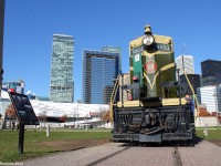 On a peaceful Sunday afternoon in downtown Toronto, CN 4803 sits retired at Roundhouse Park on display, something it has been doing for many years. In the background is the Toronto skyline, to the left a portion of the CN Tower can be seen, standing 457M in the air, and a display sign noting several things about #4803.