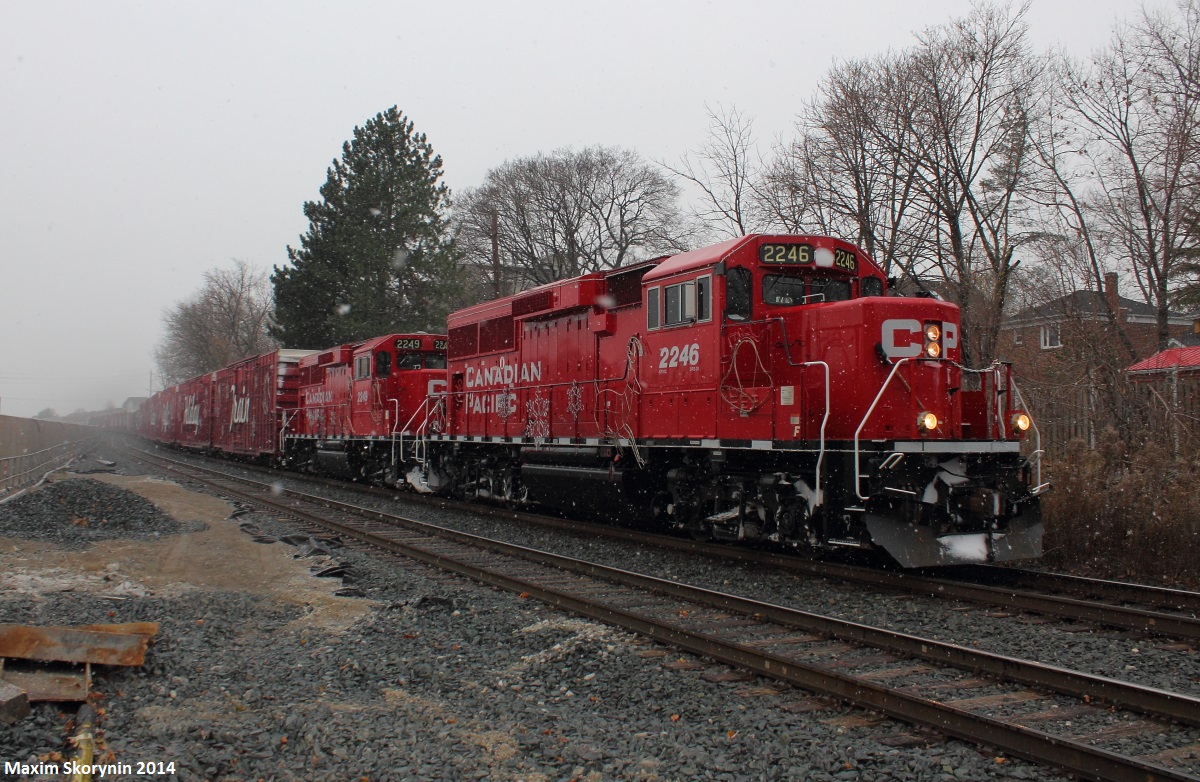 Here are 2 signs of winter, snow falling, and of course, the Canadian Pacific Holiday Train. As I woke up this morning, I got a a timely notification that both Holiday Train consists (The U.S and Canadian) were running together to Montreal, where they'll split and go their directions at the end of the month. I thought it'd be pretty cool, and as I got a notification that they passed Palgrave, Ontario I immediately headed out to the tracks with about 10 minutes to spare to set up my camera. My zoomed in shot didn't turn out as good as the camera focused on the snow instead of the train, but thankfully I grabbed this shot which came out fine before the train passed. See www.cpr.ca for the schedule of the Holiday Train. The train stops in major cities and towns, with the Christmas lights on, and viewers can watch for free, however are encouraged to donate a non-perishable food item for a local food bank. There will also be a performance at every stop.