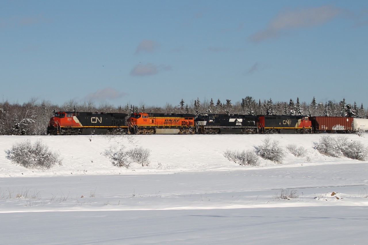 More and more crude trains are coming to the Maritime provinces for unloading at the Irving refinery in Saint John NB.  Today shows a colourful U700 on the Sussex Sub with CN 2611, BNSF 749, NS 9812 and CN 2454 in an all GE consist.